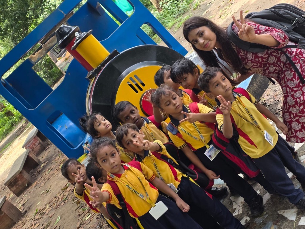 Children on a train play structure during a field trip