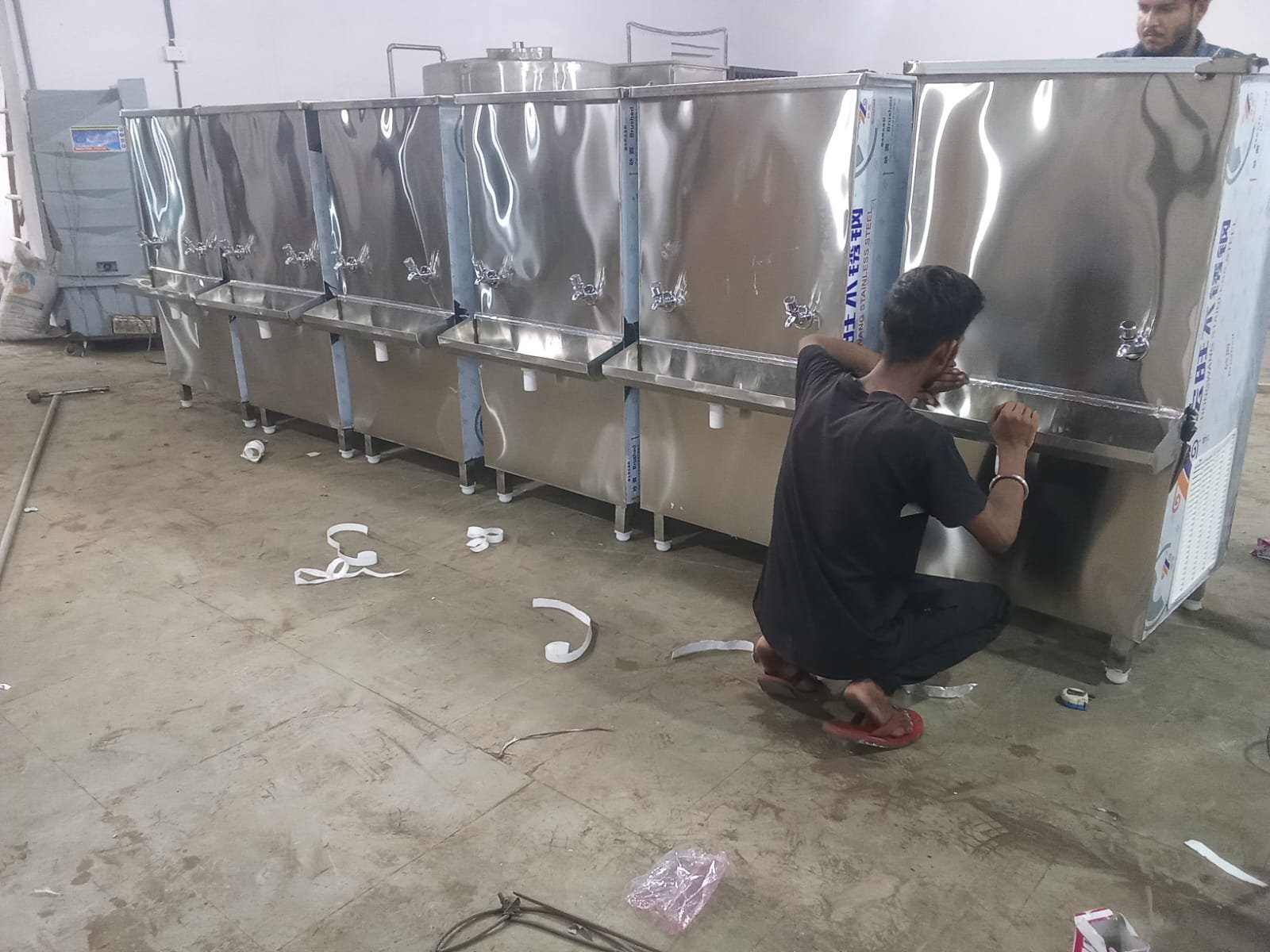 Technician finishing a bulk order of water coolers