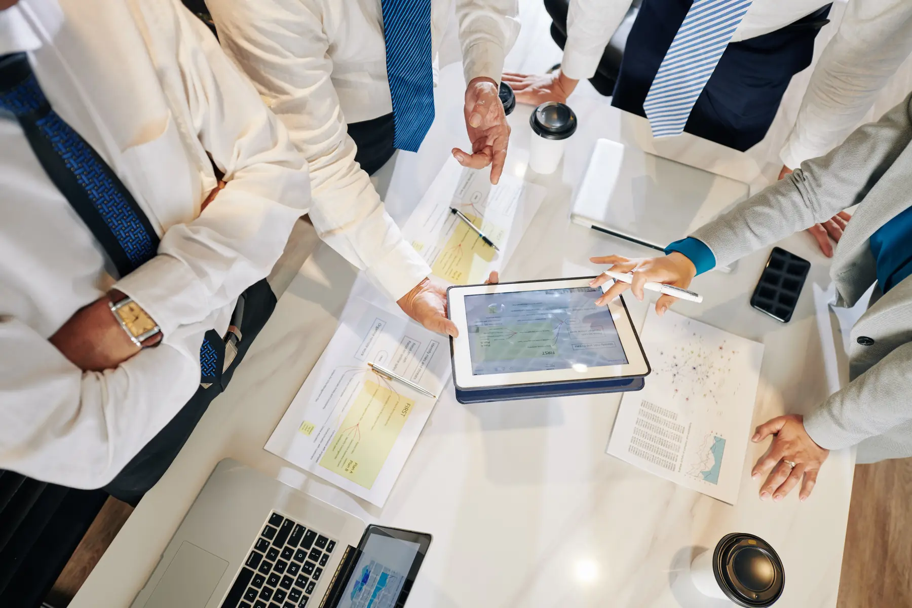 Team reviewing sourcing data around a table