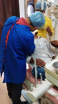 Dr. Prabhu Singh treating a patient with an assistant