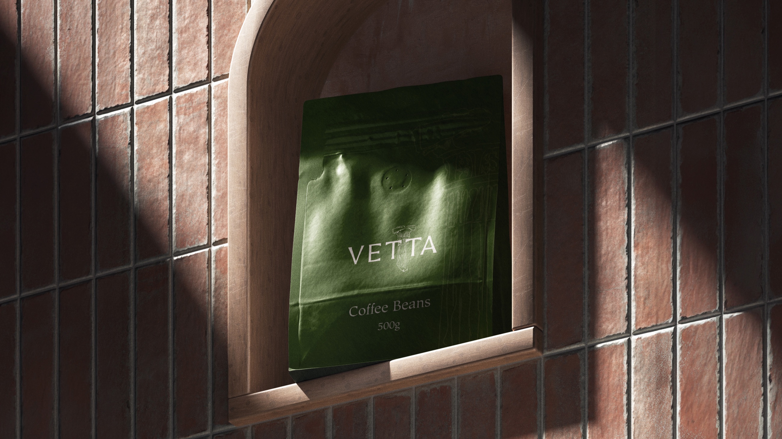 A green VETTA coffee pouch standing in an arched niche of a brick wall, lit by raking sunlight